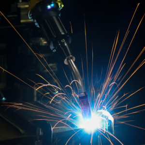 TOUGH GUN TA3 robotic air-cooled MIG gun in action with colorful welding sparks