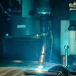 Image of robotic MIG gun welding a piece of metal